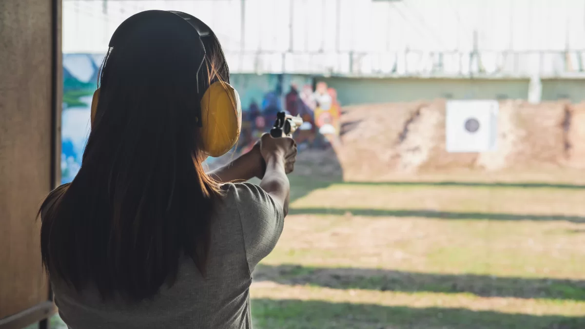 a woman at a shooting range practicing for a concealed weapons class