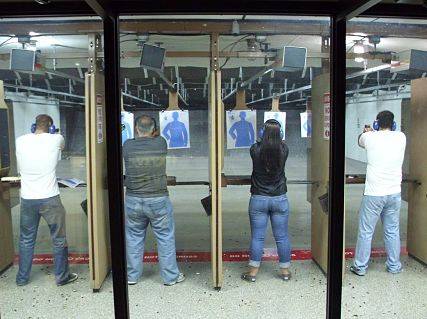 Men and women practicing on the gun range for Chicago Firearm Training.